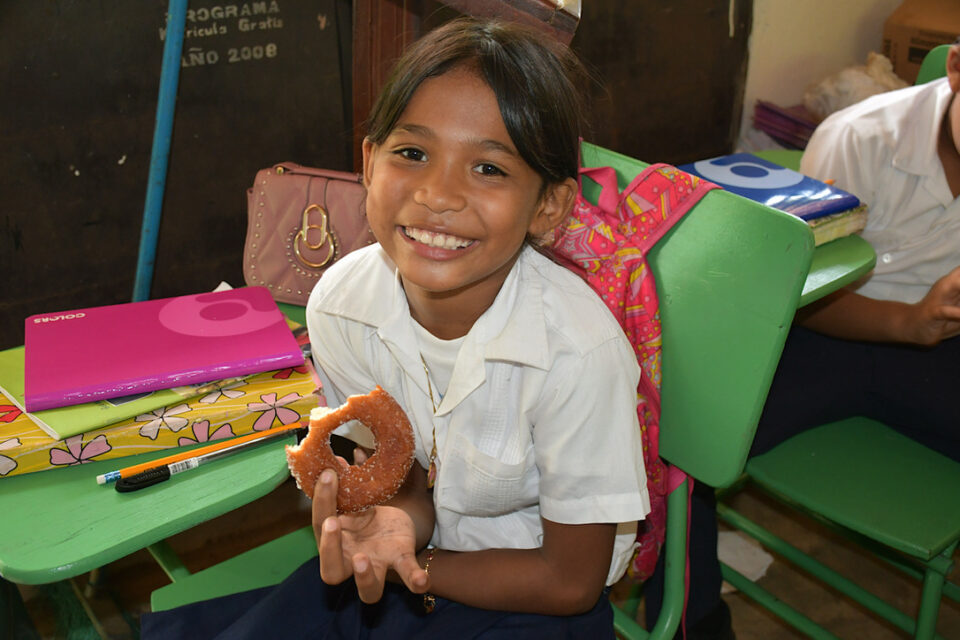 Ed Lockett Honduras kid with donut 8-28-2023